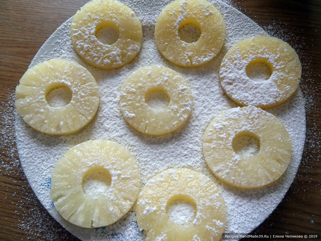 Консервированные кольцами ананасы обсушить на салфетке. Посыпать сахарной пудрой и оставить на 10 минут