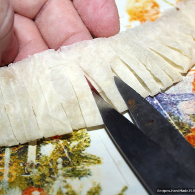 Согнуть полоску лаваша пополам по ширине (получается 2,5 см), сделать ножницами надрезы